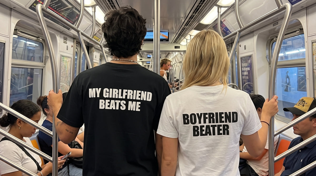 Two people on a subway train wearing t-shirts with humorous text.